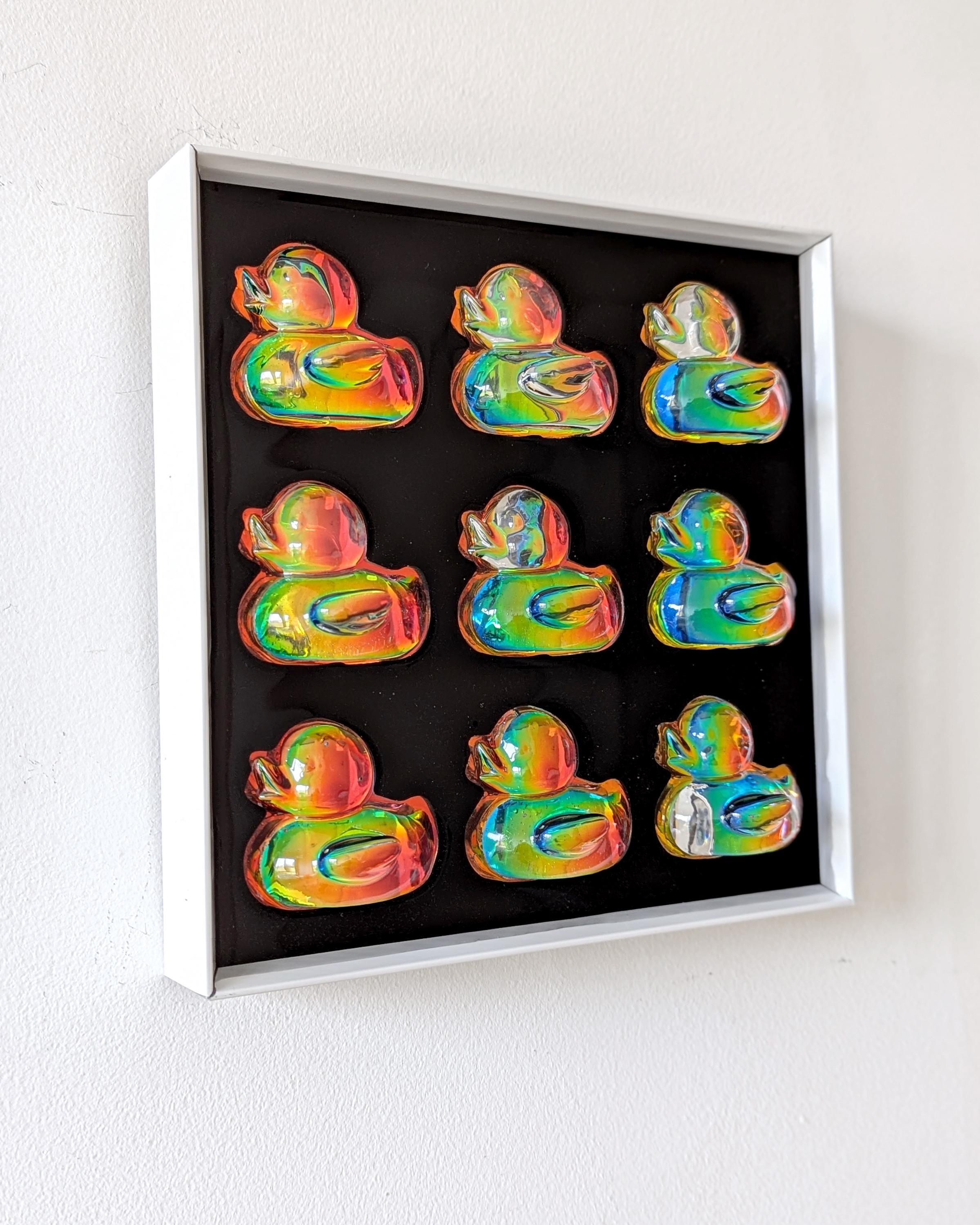 Holographic duck framed wall art against light background – playful modern wall decor